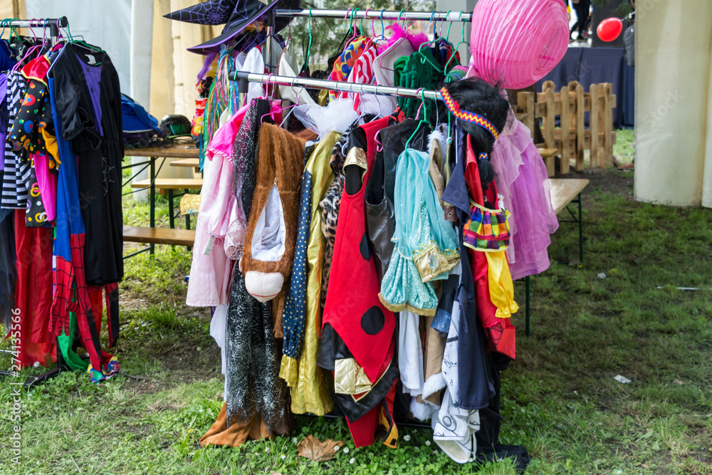 All kinds of colorful costumes for carnival or children plays in the backstage of an outdoor festival.