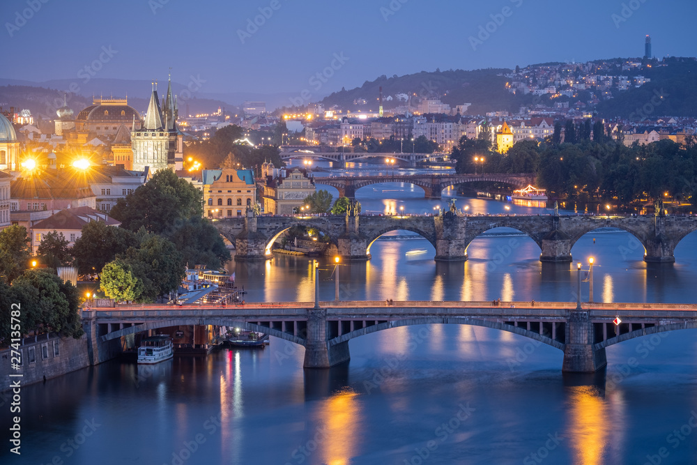 Blue hour scene of Prague bridges under the lights
