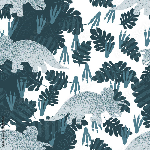 Fotografija Gray dinosaur Triceratops on a white background surrounded by leaves and traces