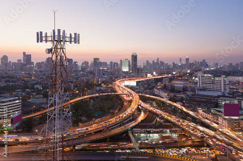 Fototapeta Naklejka Na Ścianę i Meble -  Telecommunication tower with 5G cellular network antenna on city background