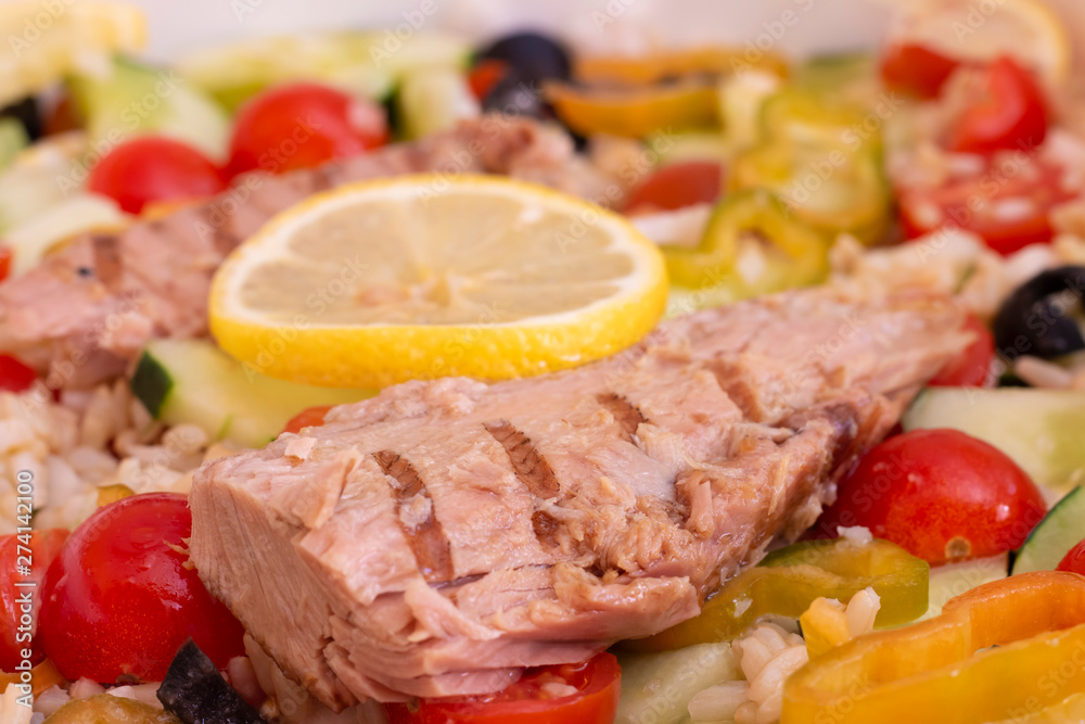 Close-up of rice salad with fresh vegetables and grilled mackerel Close-up of rice salad with fresh vegetables and grilled mackerel