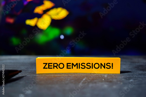 Zero Emissions! on the sticky notes with bokeh background