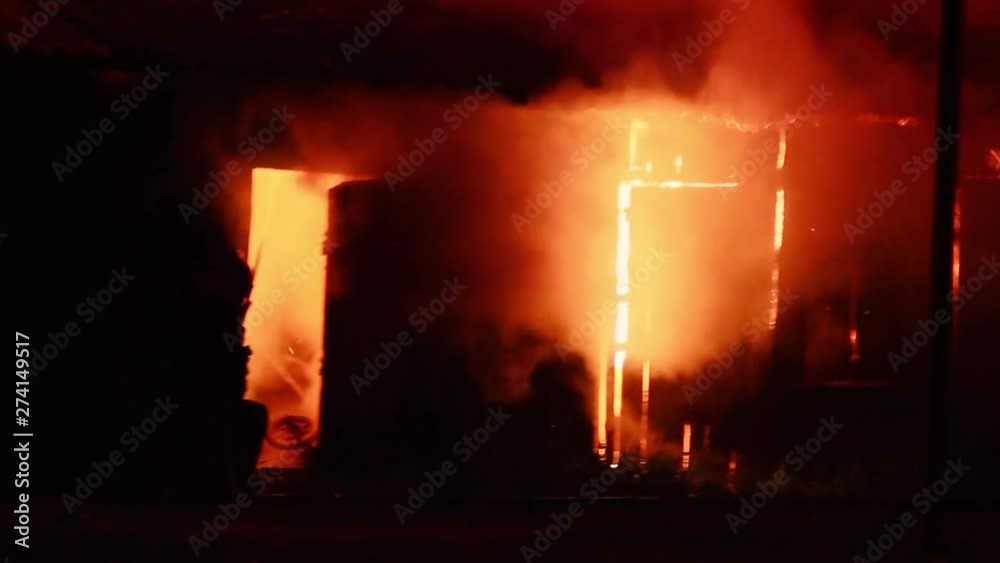 disaster, fire in a wooden warehouse. rescue service, firefighters extinguish the fire.