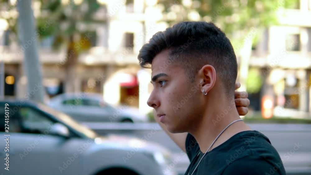 Closeup of young fashionable handsome man on the street of modern city. He is smiling and looks happy. New generation Closeup of young fashionable handsome man on the street of modern city. He is smiling and looks happy. New generation
