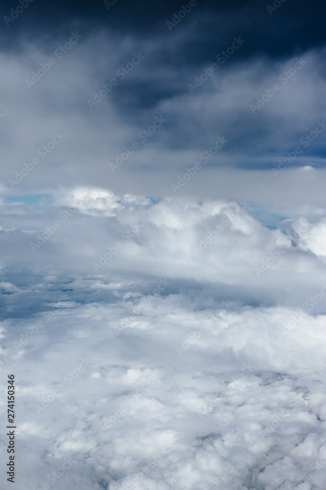 Plane window view with blue sky and beautiful clouds. As seen through window of an aircraft. View of wing & ocean. Airplane from city Bangkok to island Bali. Plane window view with blue sky and beautiful clouds. As seen through window of an aircraft. View of wing & ocean. Airplane from city Bangkok to island Bali.