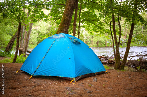Tent camping in the woods at daylight in summer