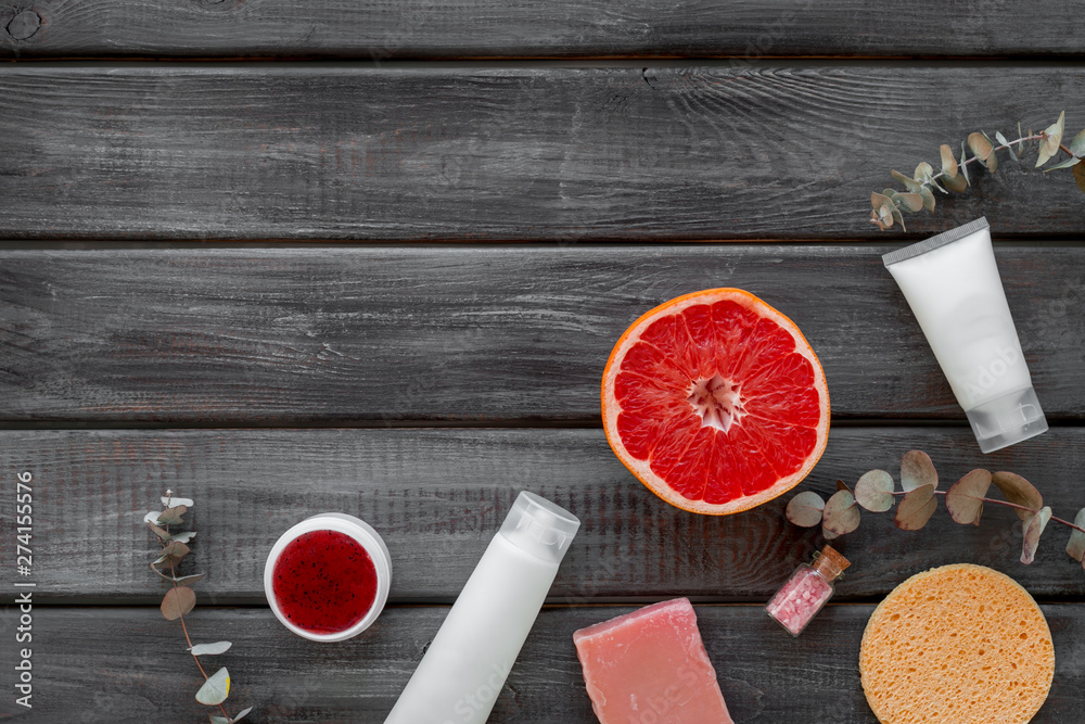 Natural herbal cosmetics with grapefruit on wooden background top view space for text Natural herbal cosmetics with grapefruit on wooden background top view space for text