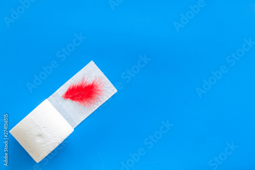 disease of colon concept with toilet paper roll on blue background top view space for text