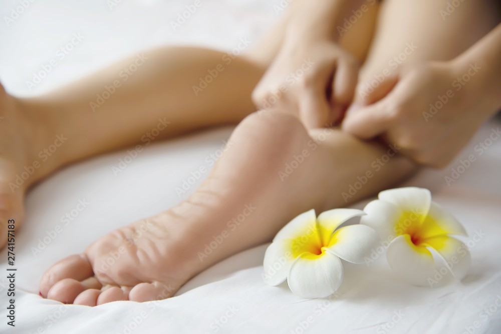 Woman receiving foot massage service from masseuse close up at hand and foot - relax in foot massage therapy service concept
