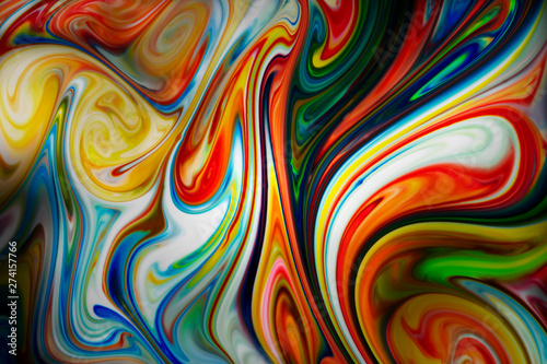 Colorful liquid paints mixed together creating abstract