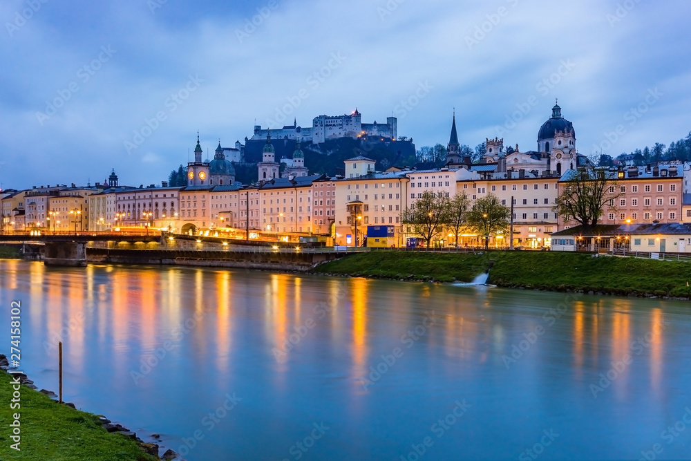 Beautiful view of Salzburg skyline with Festung Hohensalzburg and Salzach river at blue hour, Salzburger Land, Austria