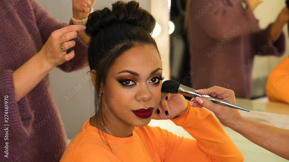 Portrait stylish African American. Girl posing in beauty salon with high  hairstyle and make-up party. Work of professional makeup artist and  hairstylist. Beauty industry Stock Photo | Adobe Stock