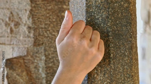 Hand Knocks on Ancient Colored Column As Old Tradition