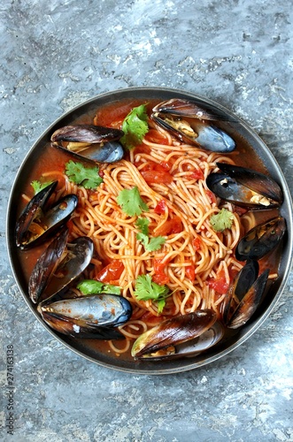 Pasta Spaghetti with mussels, tomato sauce. sea food meal. Mussels Marinara. Typical dish of Italian pasta.  top view.