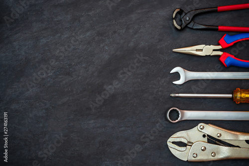 Craftsman tool on black cement background. Copy space for your text. Concept of maintenance to be reused as before.