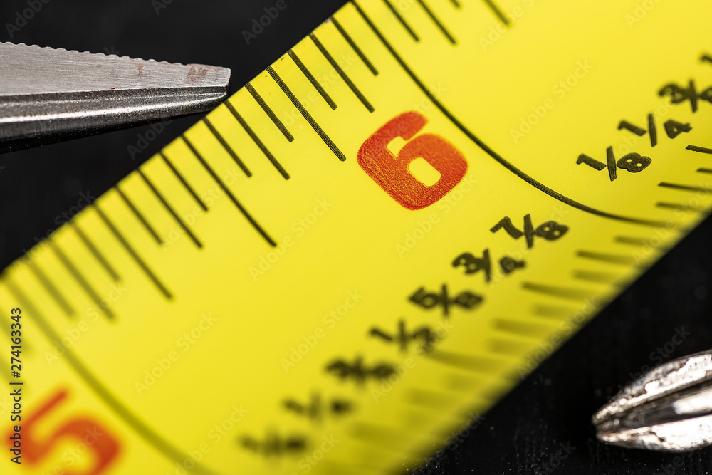 A macro image of a yellow Tape Measure A macro image of a yellow Tape Measure