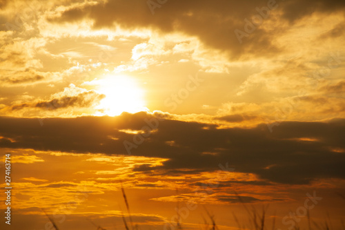 Evening weather, Golden sky and cloud with Light sunshine, Dark shadow meadow in the field.