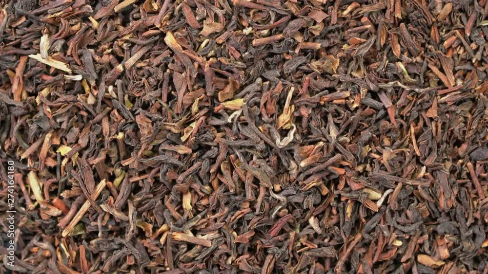 loose leaves of darjeeling black tea background - overhead view on turntable