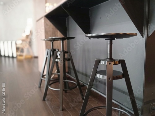 Vintage row of steel chairs in the bar with light shining on it in a bright room selective focus.