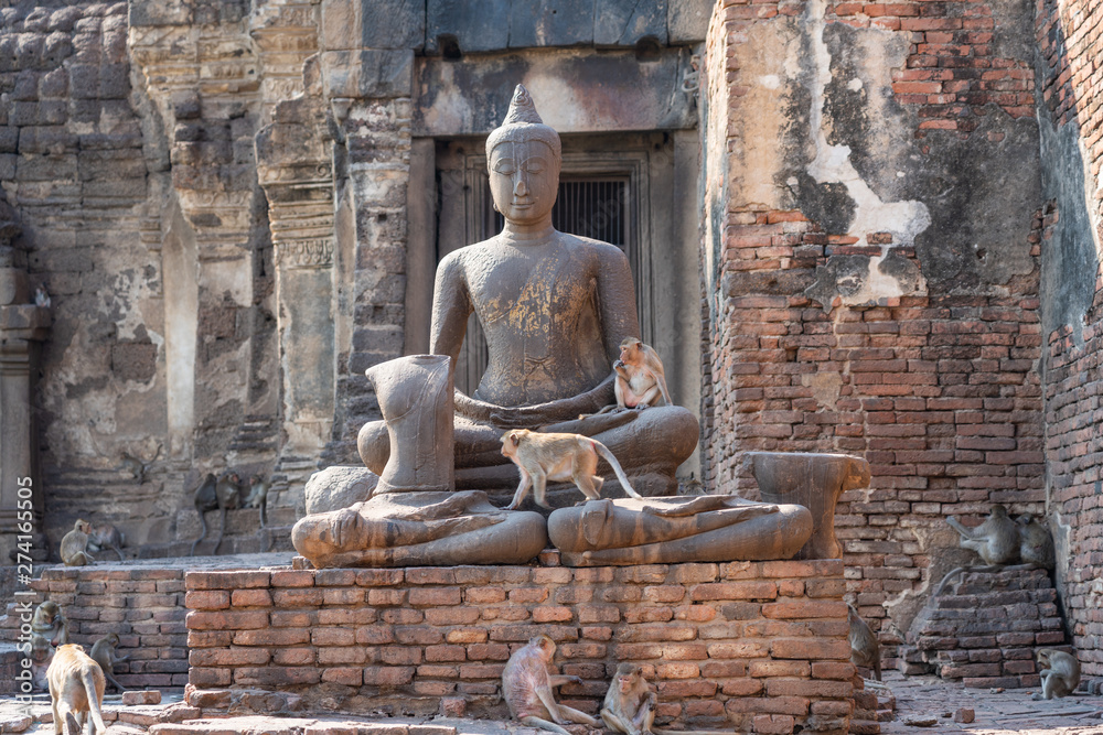 Fototapeta premium Monkeys with stone Buddha Sculpture