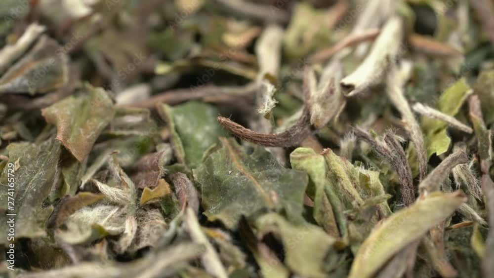 loose leaves of Bai Mudan white tea background - low angle view on turntable loose leaves of Bai Mudan white tea background - low angle view on turntable