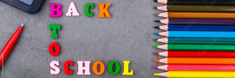 The layout of school supplies on a dark gray background. The view from the top. Flat lay. Back to school. The layout of school supplies on a dark gray background. The view from the top. Flat lay. Back to school.