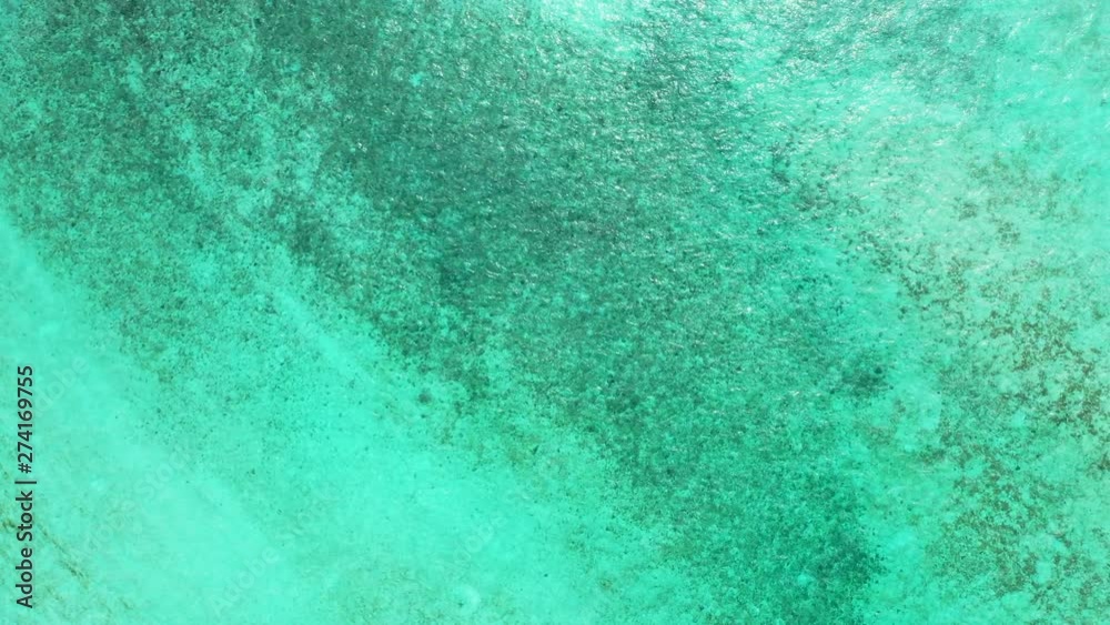 caribbean top down aerial shot of clean ocean water with rocks and sand visible underwaterr caribbean top down aerial shot of clean ocean water with rocks and sand visible underwaterr