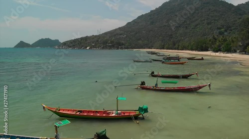 Aerial drone footage of Sairee (Sai Ri) Beach, Koh Tao, Thailand.
Ocean, corals, blue sea and long tail speed boats can be seen in the foreground with Sairee beach behind. photo