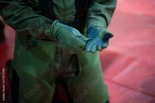 solder wearing gloves in hands of The explosive ordnance disposal suit