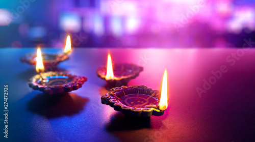 Colorful clay diya lamps lit during diwali celebration photo