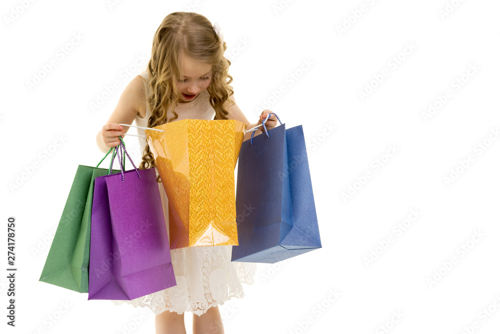 Little girl with multi-colored bags in their hands.