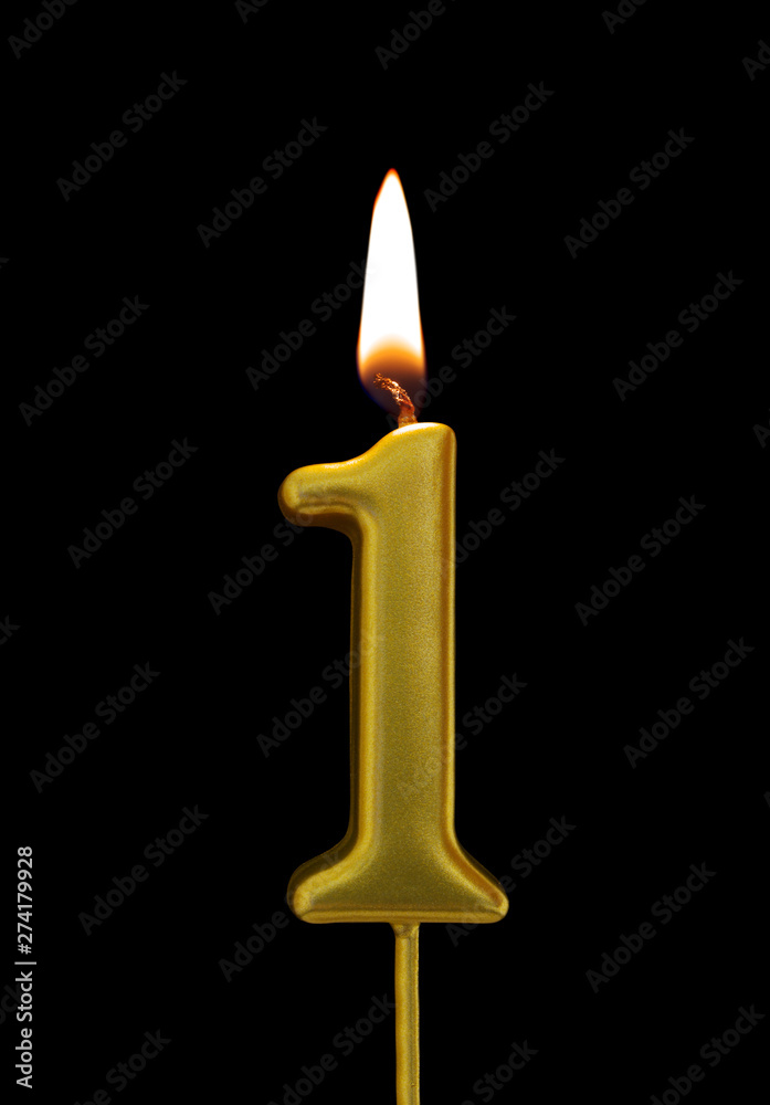 Burning birthday golden candle isolated on black background, number 1 Burning birthday golden candle isolated on black background, number 1