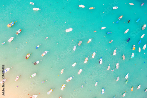 Boats in the harbor of Mediterranean fishing village, aerial view.