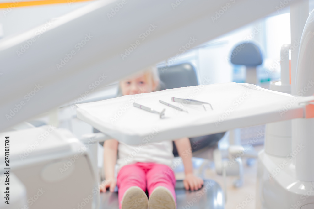 little girl in the dental chair. control at the dentist.