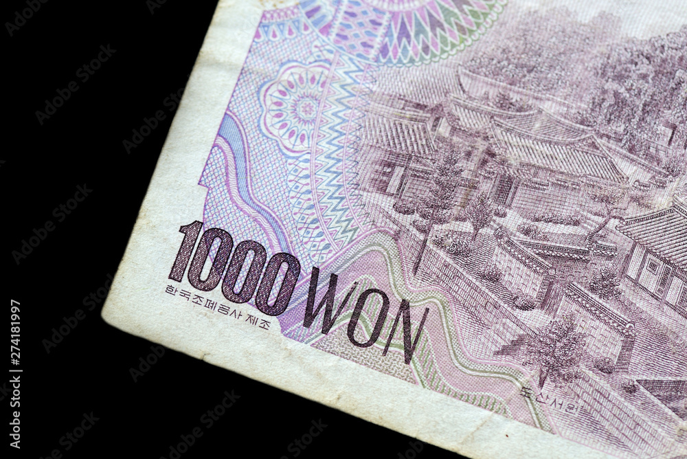 Fototapeta premium Outdated 1000 Korean Won note of 1983 issued on a black background close-up