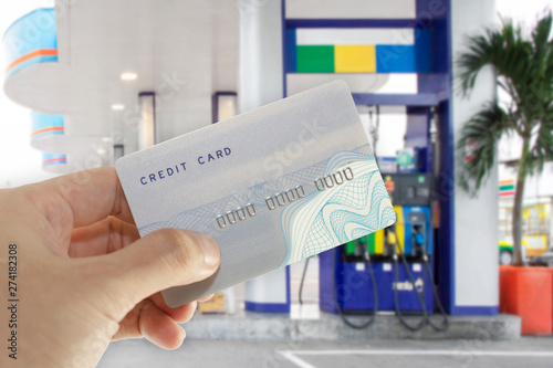 Credit card with mobile phone to make a payment for refueling car on gas station