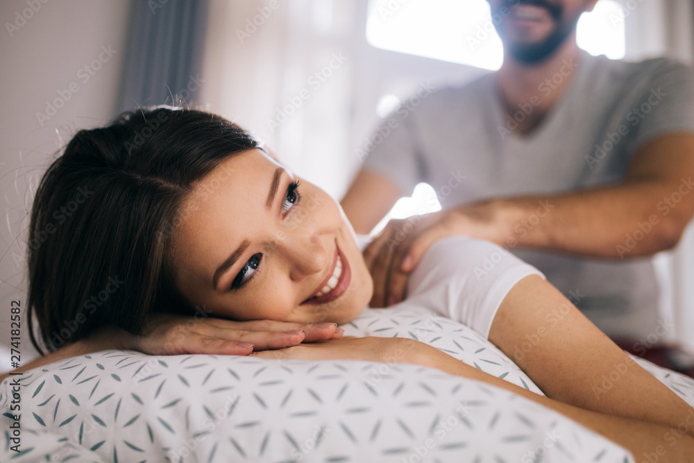 Foto de Couple and lovely moments in the bed. Boyfriend giving massage for  his beautiful girlfriend do Stock | Adobe Stock