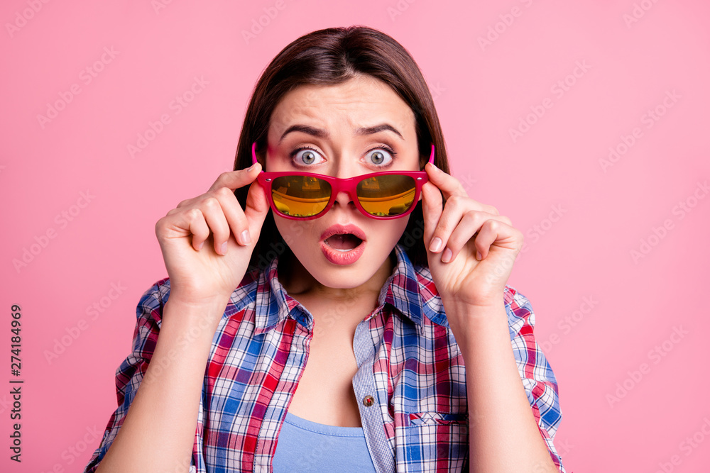 Close up photo astonished funny funky lovely teen teenager disappointed frightened hear horrible terrible gossip rumor secret scream touch bright specs plaid clothes isolated pastel pink background