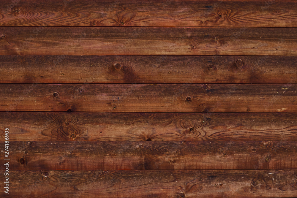 Obraz premium Texture of brown shabby wooden fence. Old wooden boards with nails. Pattern of wooden surface of logs. Background of old shabby table, dirty oak, alder tree, pine lumber.