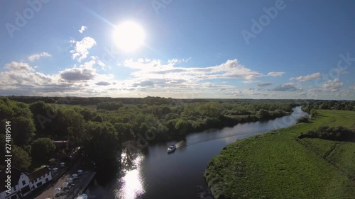 Aerial Drone Footage of a boat sailing along the River Yare, Norfolk. photo