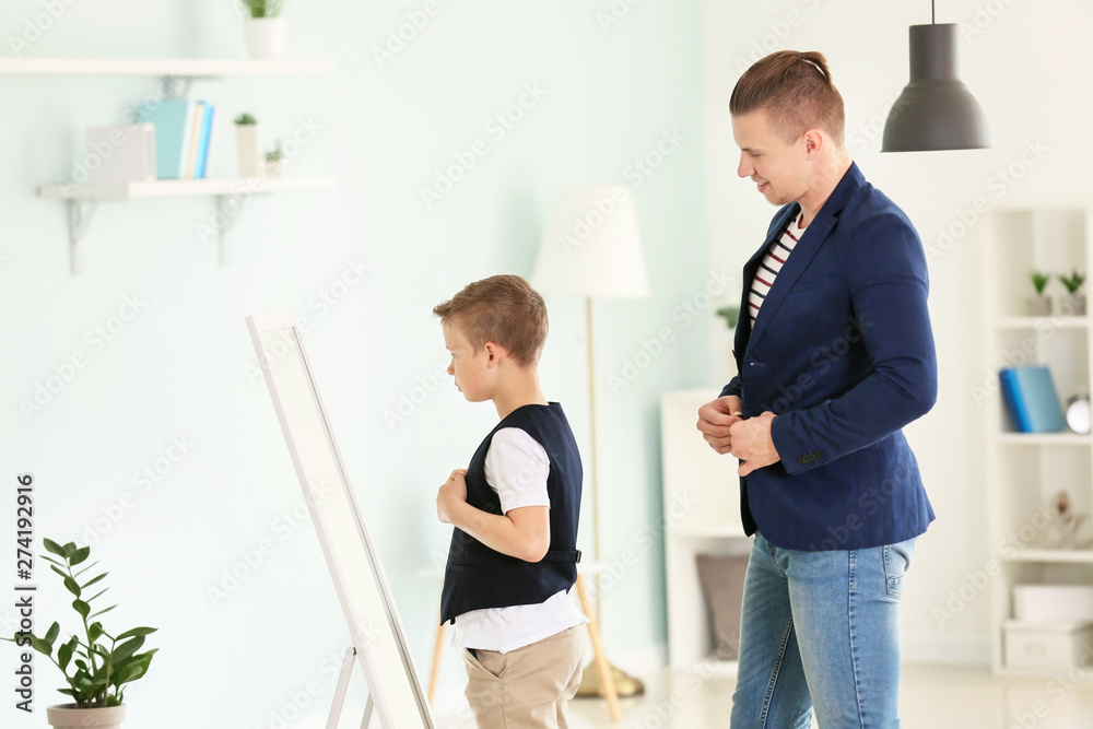 Fototapeta premium Father and son in fashionable clothes at home