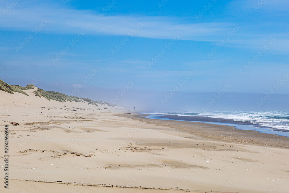 Looking along a sandy beach in Oregon on a sunny but windy summers day Looking along a sandy beach in Oregon on a sunny but windy summers day