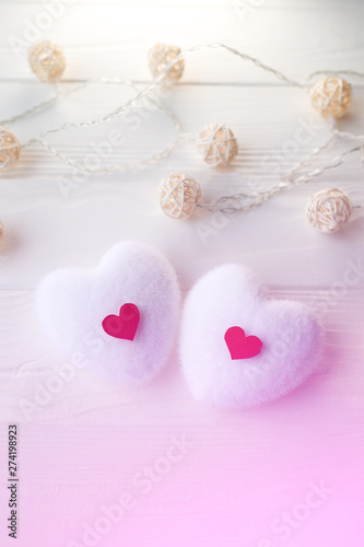 Red and white hearts on wooden background. Saint Valentine's day concept. Love and romantic photo. Postcard for holiday. Small rustic lights. Vertical.