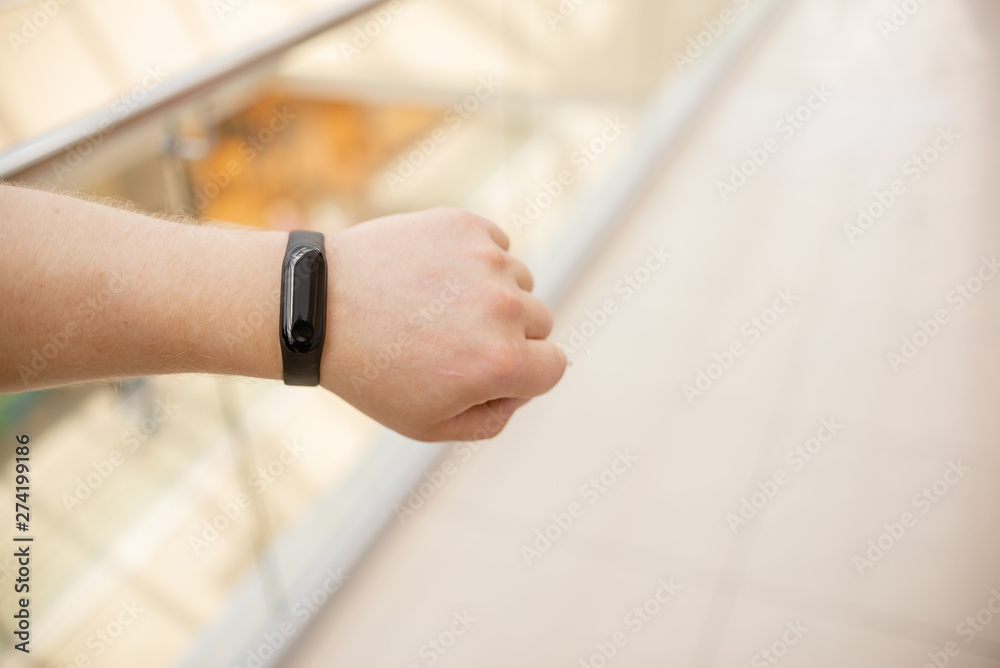 Man is wearing a fitness bracelet. Smart watch on the hand of a man. Pensioner Using Fitness Tracker.