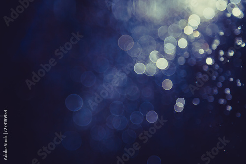 bokeh of water fly and lights on black background,