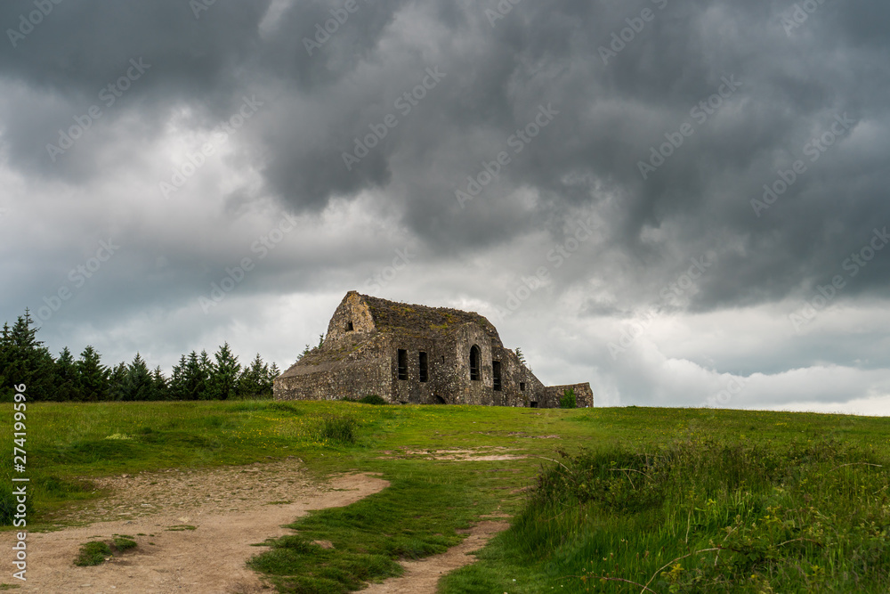 The famous haunted ruins of the Hell Fire Club built in the year 1725 on the Montpellier Hill in Dublin, Ireland. Well know landmark surrounded by mystery and horrifying legends under a stormy sky.
