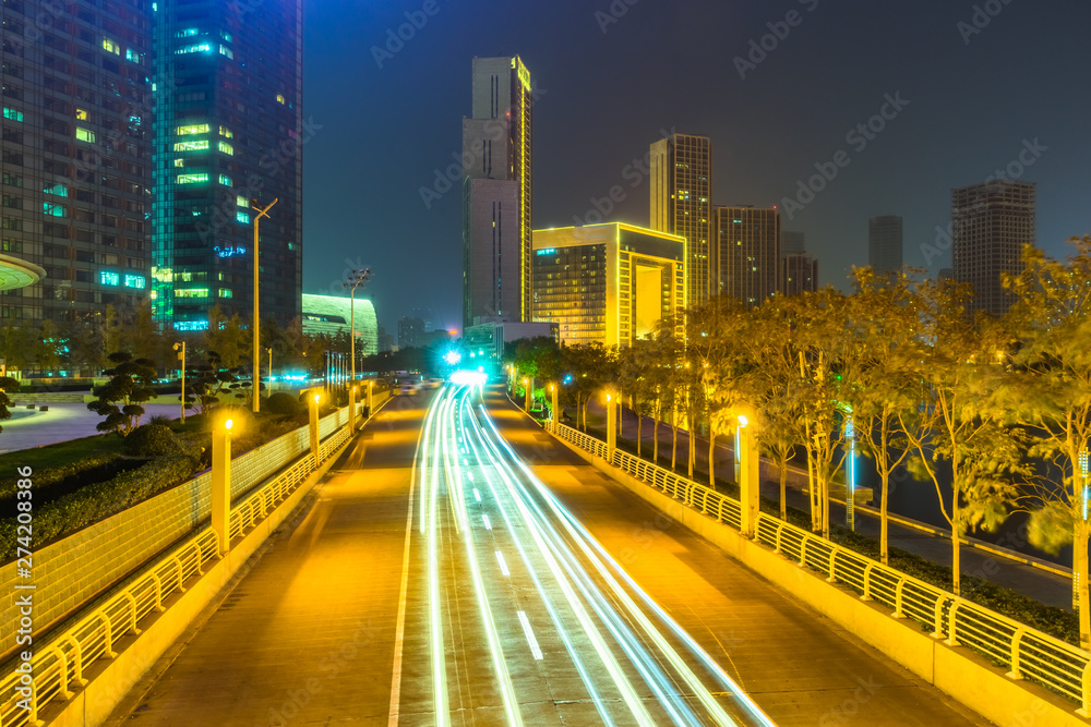 Fototapeta premium traffic light through city at night in china