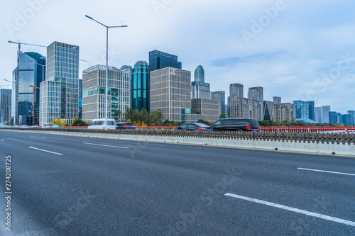 cityscape and skyline of shanghai from empty asphalt road.