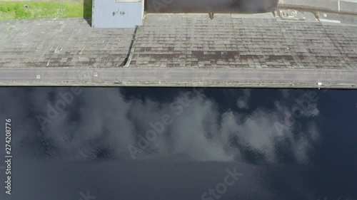 An aerial, close overhead view of Loch Cluanie and Cluanie dam. Top-down view of the loch water with the dam entering from top of frame. photo