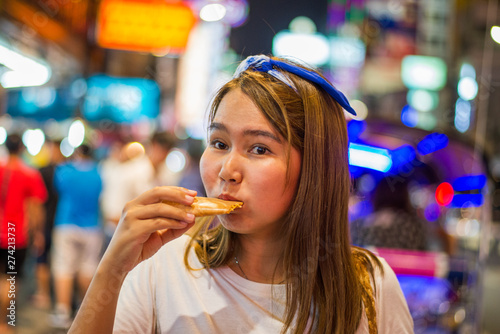 Asian young woman travel in China town at Thailand at Night Woman travel and eating Night street food market at Yaowarat road  China town Bangkok  Thailand 